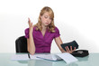 Foto: Exasperated woman with a calculator Exasperated woman with a calculator