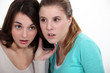 Photo: Girls listening to a cellphone Girls listening to a cellphone