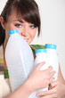 Photo: Young woman recycling plastic bottles Young woman recycling plastic bottles