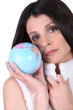 Photo: Woman in a furry gilet holding a globe Woman in a furry gilet holding a globe