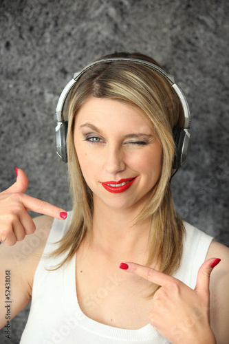 Photo: Woman winking with audio headphones Woman winking with audio headphones