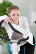 Photo: Young woman using an exercise machine Young woman using an exercise machine