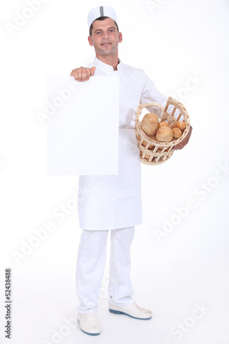 Photo: A baker presenting a blank poster. A baker presenting a blank poster.