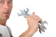Photo: Man holding spanners Man holding spanners