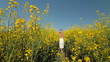 Child going away on the yellow blossoming field