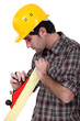 Carpenter using a wood plane