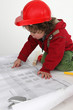 Little boy builder reading newspaper