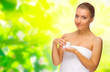 Young healthy girl with body cream on floral background