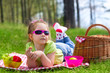Little girl eating grapes at picnic