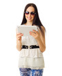 Girl in sunglasses and blue pants with tablet PC