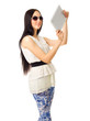 Girl in sunglasses and blue pants with tablet PC