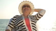 Happy senior woman enjoying vacation at the seaside