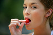 Photo: Woman eating a cherry Woman eating a cherry