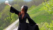 The girl in a black cloak. In the hands holding a mirror ball.