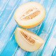 Sliced Galia melon on wooden boards, studio shot