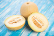 Ripe Galia melon and its halves on wooden boards