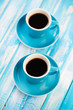 Vertical shot of two espresso cups with black coffee