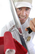 Decorator using ladder and paint roller