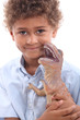 Little boy playing with toy dinosaur