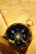 Vintage compass on blank yellowed paper
