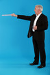 Photo: A businessman pointing with a ruler. A businessman pointing with a ruler.