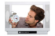 Man inside television looking at alarm clock