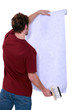 Photo: Man with a roll of wallpaper Man with a roll of wallpaper