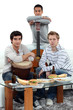 Foto: Young men at home with musical instruments Young men at home with musical instruments