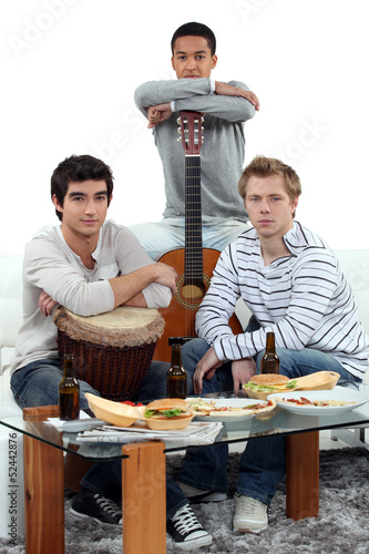 Photo: Young men at home with musical instruments Young men at home with musical instruments