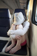teenager girl wearing hat  sitting in the carrige crying