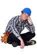 Foto: Bored manual worker sat cross-legged Bored manual worker sat cross-legged