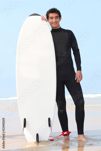 Photo: young surfer posing with board young surfer posing with board