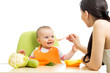 Foto: mother feeding baby girl mother feeding baby girl
