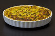 Quiche Lorraine in a white, used baking tin