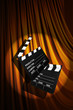 Movie clapper board against curtain