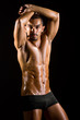 Muscular man in dark studio