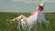 Happy senior woman relaxing on a green meadow