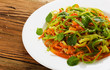 plate with mixed salad on the wooden table