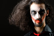 Joker personification with man in dark room
