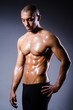 Muscular man in dark studio