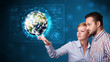 Young couple touching high-tech 3d earth panel