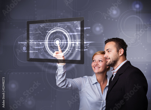 Photo: Young couple touching modern technology tablet Young couple touching modern technology tablet