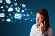 Photo: Young lady making phone call with message icons Young lady making phone call with message icons