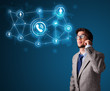 Young boy making phone call with social network icons