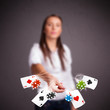 Young woman playing with poker cards and chips