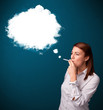 Photo: Young woman smoking unhealthy cigarette with dense smoke Young woman smoking unhealthy cigarette with dense smoke