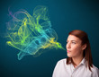 Pretty lady smoking cigarette with colorful smoke