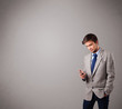 handsome boy standing and holding a phone