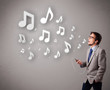 attractive young man singing and listening to music with musical