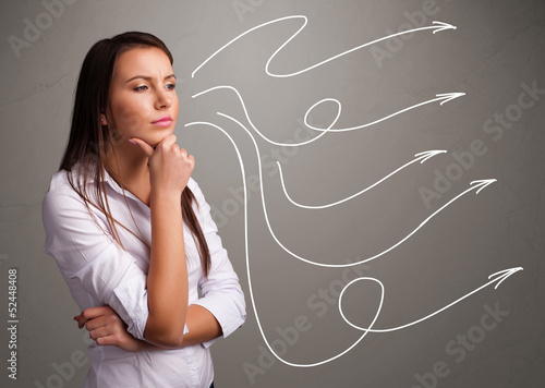 Photo: Attractive teenager looking at multiple curly arrows Attractive teenager looking at multiple curly arrows